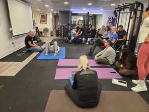 Attendees practising supine developmental positions on mats during DNS Exercise Part I at Elevate LDN