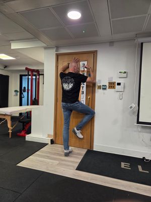 Ruud Alsemgeest demonstrating a developmental position on a treatment table during DNS Exercise Part I