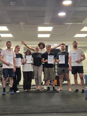 DNS Exercise Part III attendees holding their certificates after the practical exam at Elevate LDN