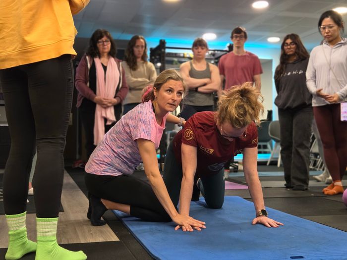 DNS instructor coaching quadruped developmental position during a course at Elevate LDN