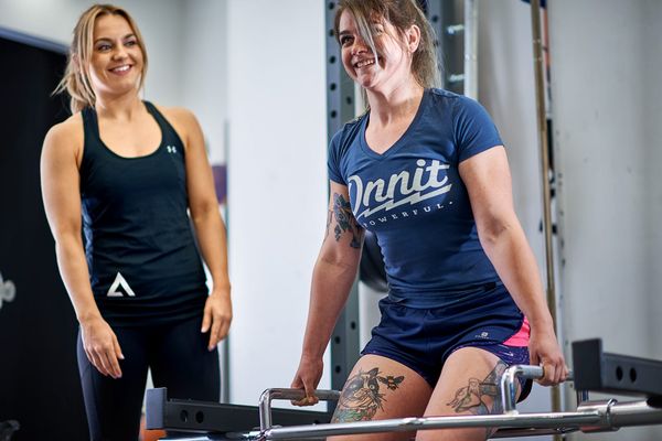 Personal trainer coaching a client in a private studio in the City of London
